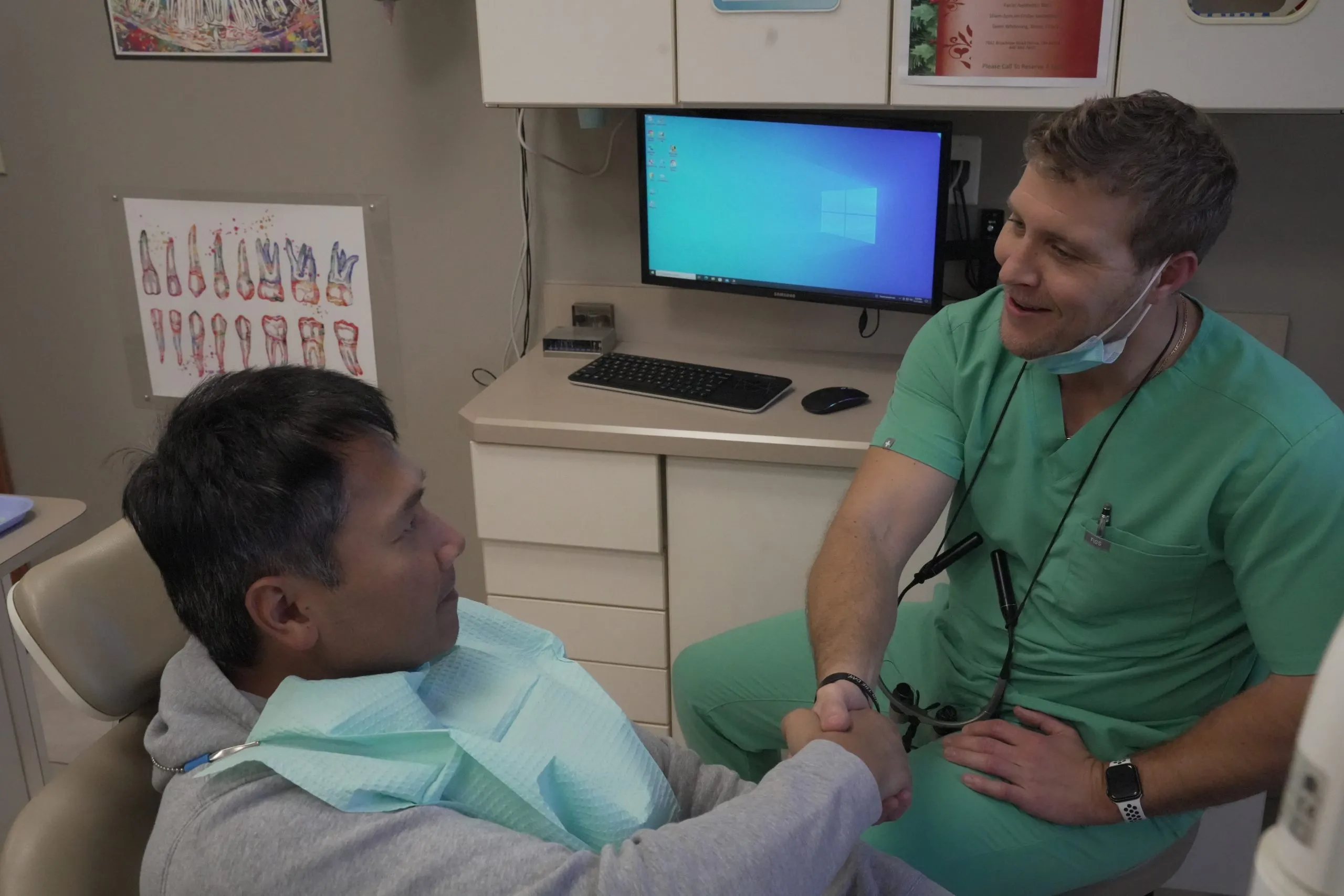 Dr. Job shaking hands with a patient at Jordan M. Job DDS